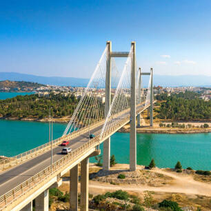View of the bridge of Evia and in the background Chalkida is shown with many houses and green trees