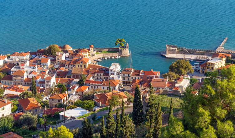Nafpaktos town from above, with many traditional houses and the walls around the town
