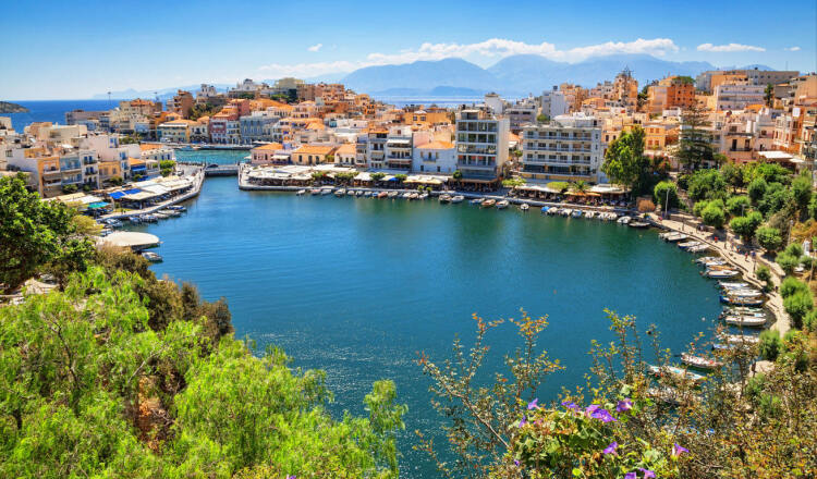 Panoramic view of port of Agios Nikolaos port, with the numerous houses and the anchored boats