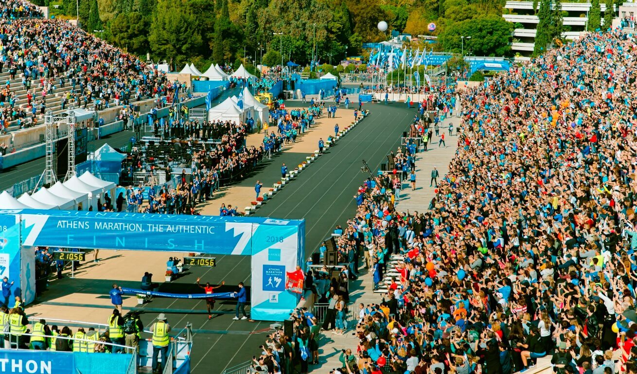 Groud cheering in a stadium where the finish line of marathon is