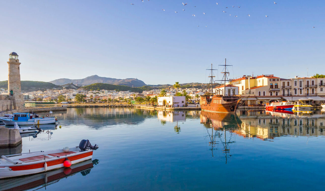 Part of the port of Rethymno, with the anchored boats, the picturesque houses and the lighthouse on its end