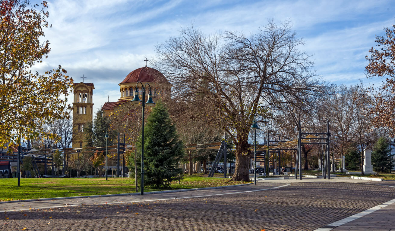 View of a parc of the town, with a church in the background