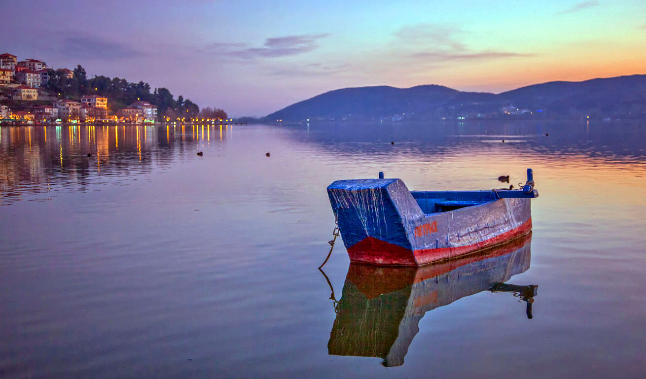 Kastoria lake at dusk, with the traditional houses surrounding it