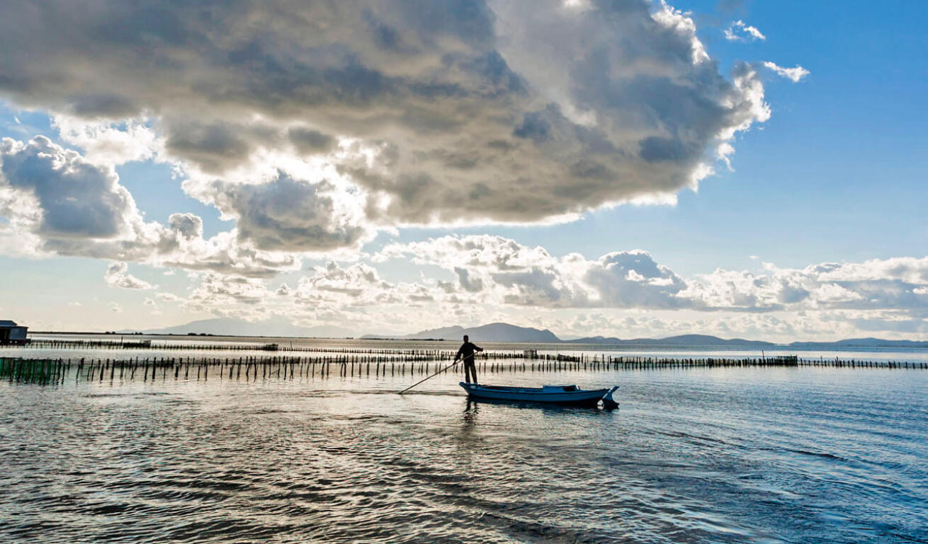 View of the sea-lake with a fisherman fishing from his boat
