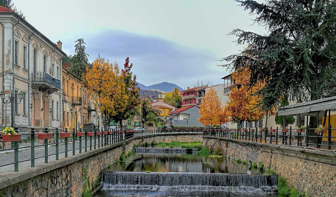 Autumn shot of houses right and left of a river.