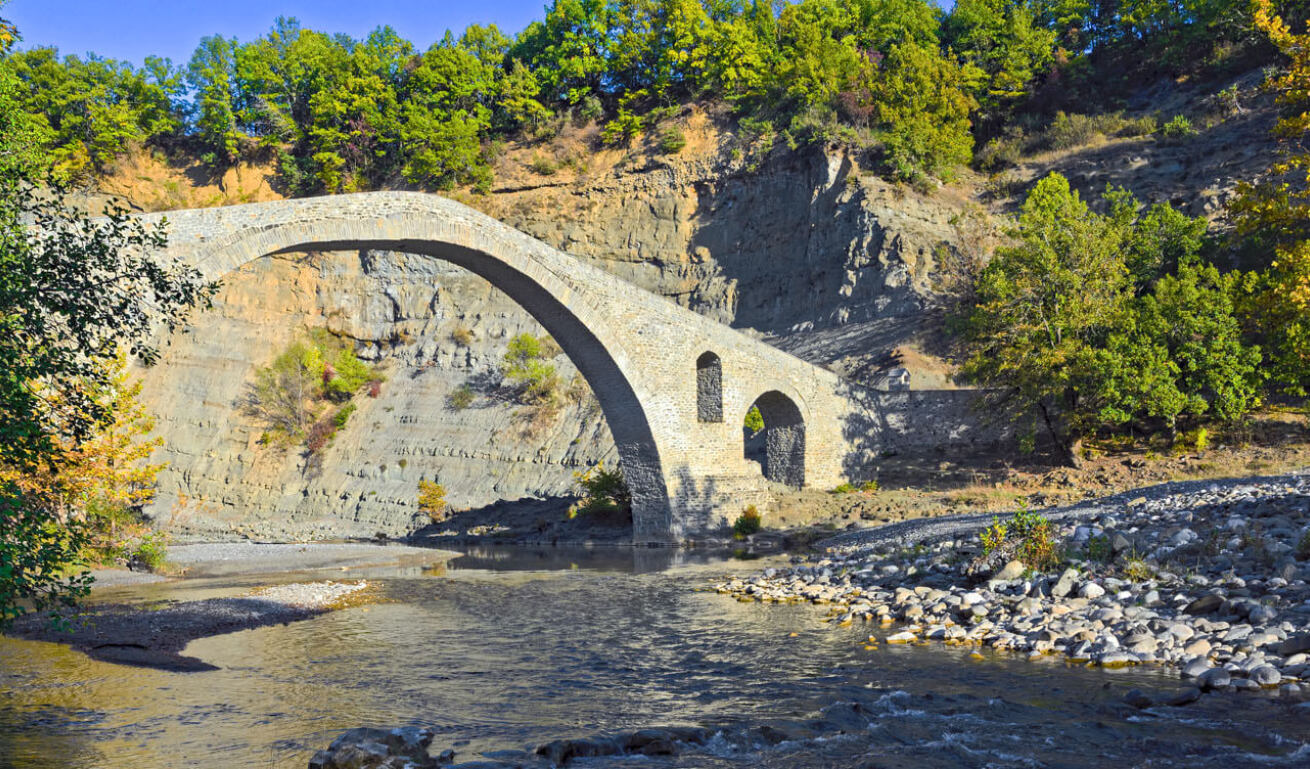 Picturesque stone-built bridge surrounded by trees