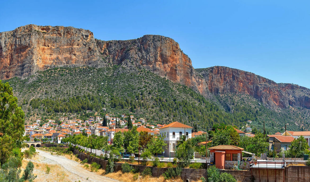 The small town of Leonidio, with the traditional houses and the trees as well as the rocks surrounding it