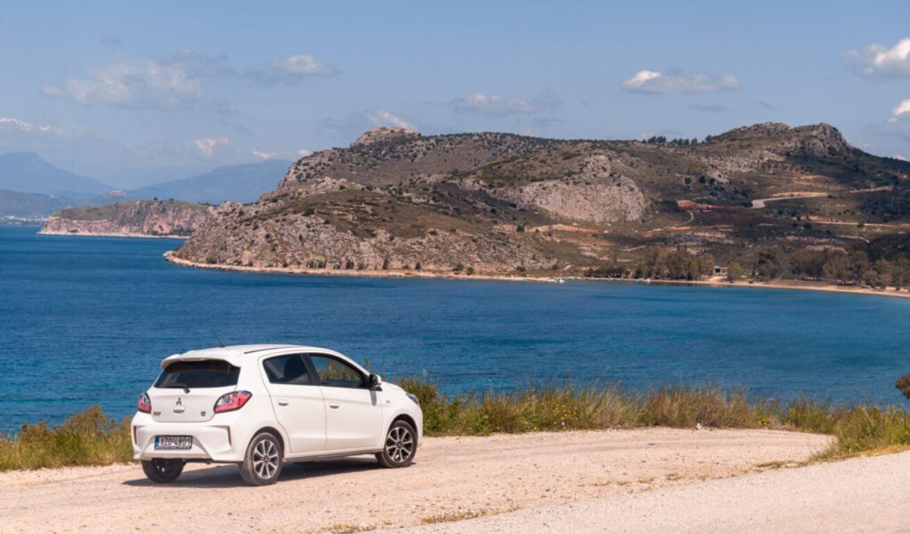 car by side of the road with coastline views