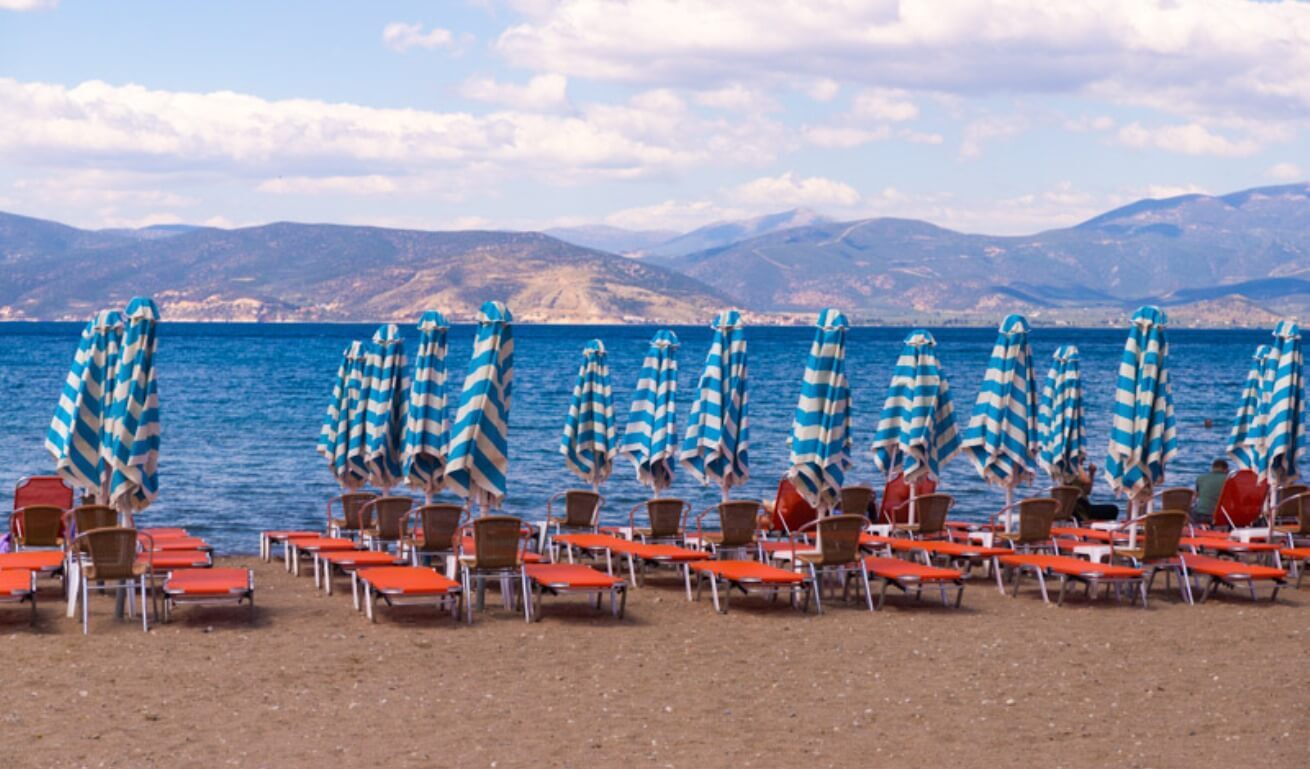 sunbeds and umbrellas on Karathona beach facing the water