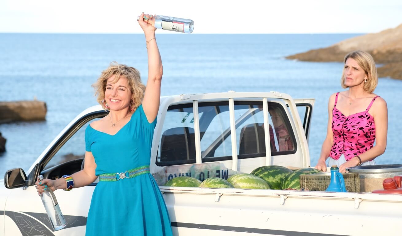 Two women outside a truck with goodies