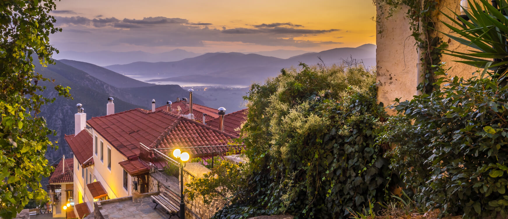 View of Delphi at dusk, with many houses with roof tiles