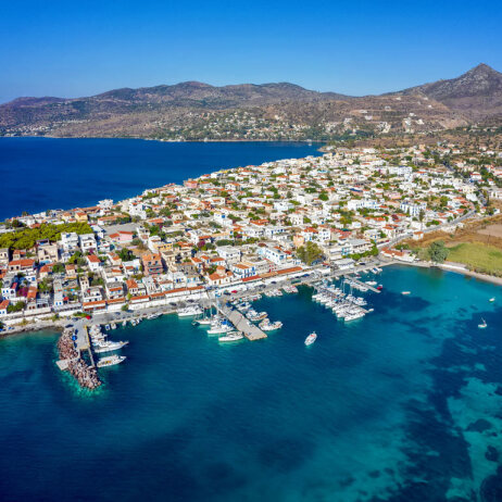 Seaside village with tiled rooftops on a peninsula.