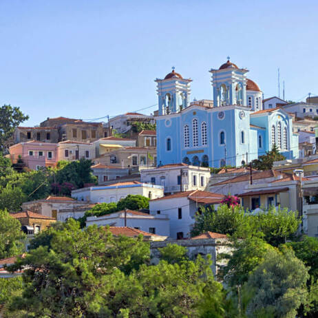 A view of Oinousses with traditional houses and the church in the background
