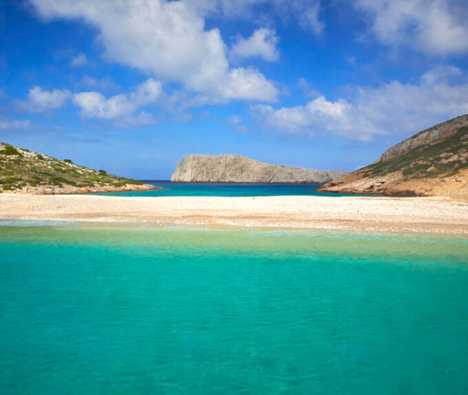 A beach with greenish blue waters in the islet of Kounoupi near Astypalaia