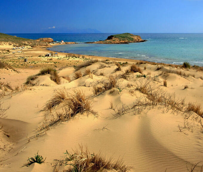 Sandy beach with a view to the greenish blue sea