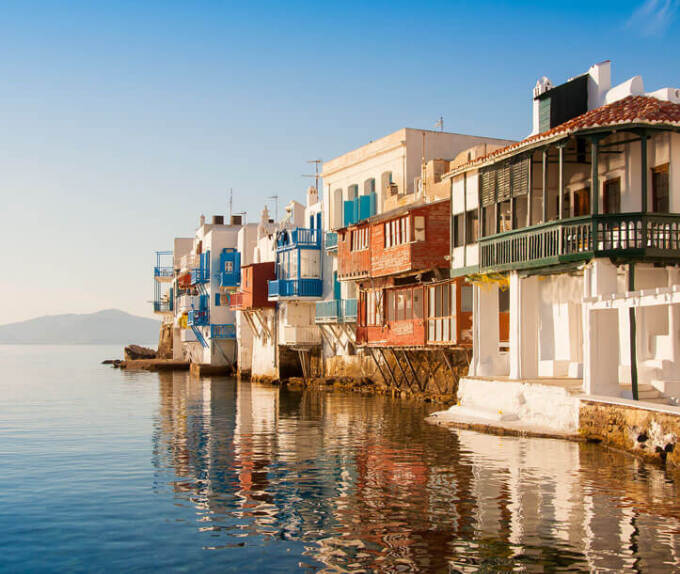 Small picturesque houses next to each other on the sea. 