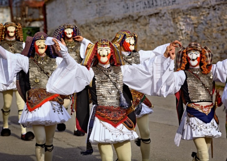 Carnival event, men in traditional carnival costumes walking down the streets