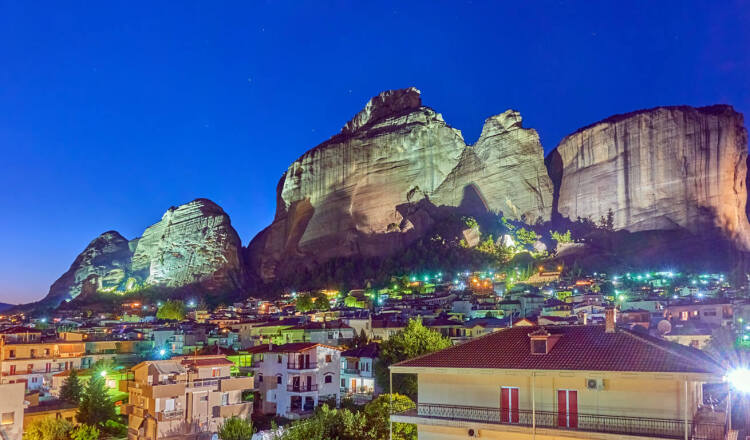 Panoramic view of the town in the evening, with the impressive rocks of Meteora in the background