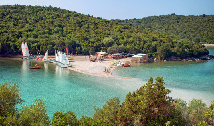 Bella Vraka beach and Mourtemeno islet with greenish blue waters and many sailing boats