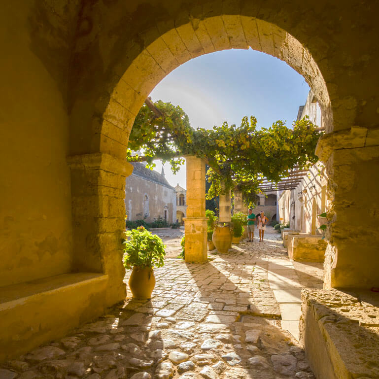 Arch in the medieval town of Rethymno, with columns in the background