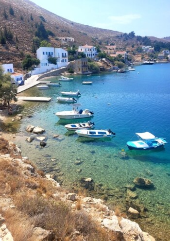 view of small seaside village with fishing boats in light green waters